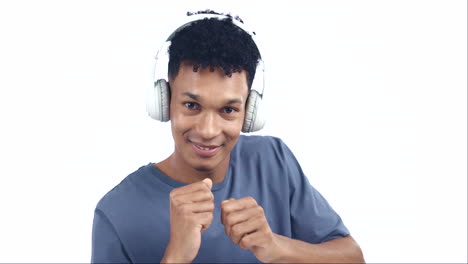 Face,-man-and-dancing-with-headphones-at-white