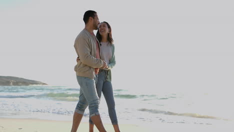 Love,-embrace-and-happy-couple-walking-on-beach