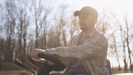 Caucasian-man-with-plaid-shirt-driving-a-quad-in-the-countryside