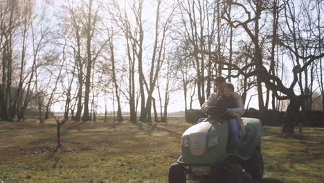 Caucasian-man-driving-a-quad-with-his-son-in-the-countryside