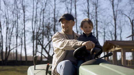 Caucasian-man-driving-a-quad-with-his-son-in-the-countryside