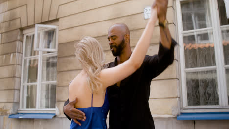 Interracial-couple-dancing-salsa-in-the-old-town-street