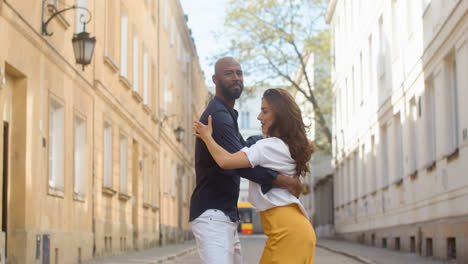 Interracial-couple-dancing-bachata-in-the-old-town-street