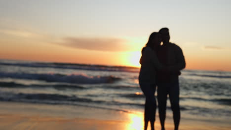 Hug,-sunset-and-couple-relax-on-a-beach