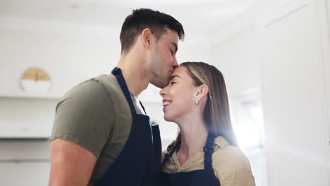 Couple,-kiss-and-feeding-food-in-kitchen