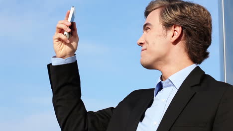 Businessman-video-messaging-chatting-on-mobile-phone