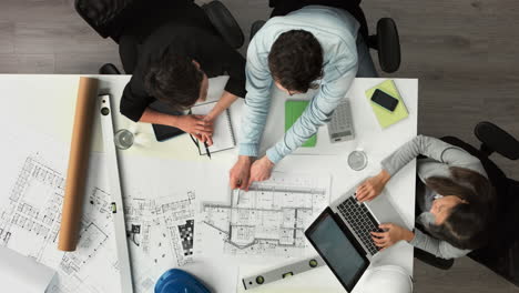 Architect-plans-arial-view-business-meeting-showing-teamwork