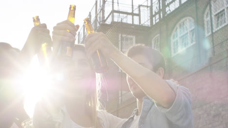 Amigos-Celebrando-Bebiendo-Cerveza-Levantando-Los-Brazos-Verano-Al-Aire-Libre