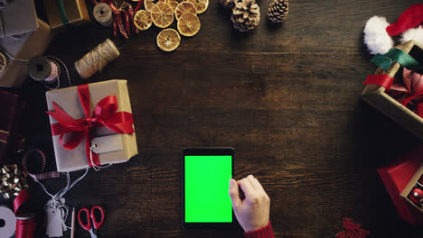 Top-view-christmas-hands-using-touchscreen-tablet-christmas-presents-shopping-list-from-above---Red-Epic-Dragon