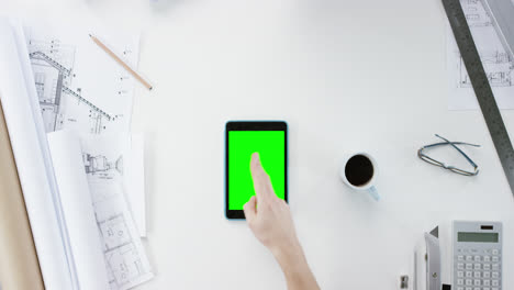 Top-view-Architect-designing-connected-home-using-digital-tablet-green-screen-hands-working-at-desk-from-above---Red-Epic-Dragon