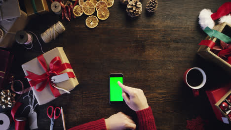 Top-view-christmas-hands-drinking-coffee-using-smartphone-shopping-online--from-above---Red-Epic-Dragon