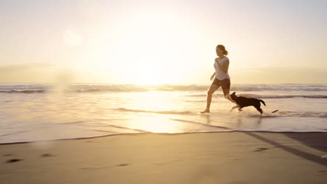 Woman-running-dog-on-beach-lifestyle-steadicam-shot