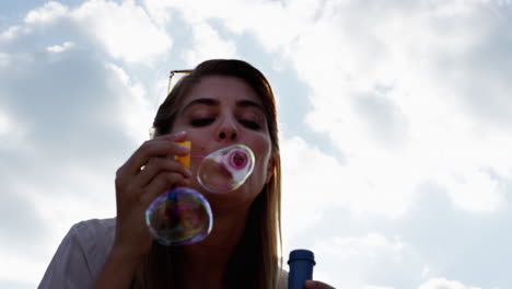 Beautiful-woman-blowing-bubbles-outdoors-sunshine-freedom-blue-sky-is-pretty