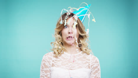 Crazy-face-woman-pulling-party-popper-slow-motion-photo-booth-blue-background