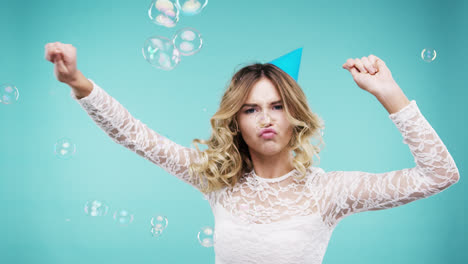 Crazy-face-woman-dancing-in-bubble-shower-slow-motion-photo-booth-blue-background