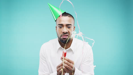 Crazy-face-mixed-race-man-pulling-party-popper-slow-motion-photo-booth-blue-background