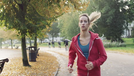 Runner-woman-running-in-park-exercising-outdoors