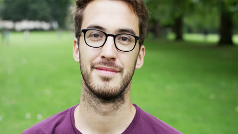 Close-up-portrait-happy-young-man-smiling-at-camera
