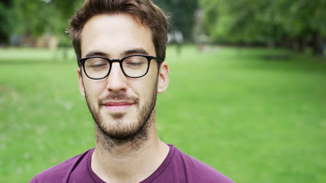 Close-up-portrait-happy-young-man-smiling-at-camera
