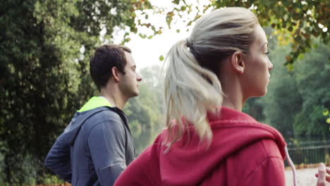 Athletic-couple-running-in-park-wearing-wearable-technology-connected-devices