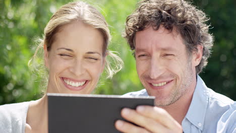Couple-browing-the-internet-on-digital-tablet-technology