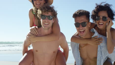 Beach-couples-giving-piggybacks-laughing-having-fun-on-vacation