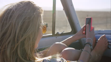 beautiful-happy-woman-taking-selfie-on-road-trip-in-convertible-car