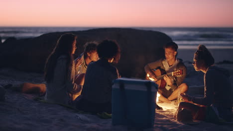Beach-Party-at-sunset-with-bonfire-and-roasting-marshmellows-with-friends