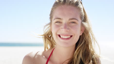 Close-up-portrait-of-beautiful-young-teenage-girl-smiling-on-tropical-beach-slow-motion
