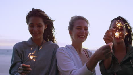 Teenage-girls-celebrating-and-laughing-with-bright-sparklers