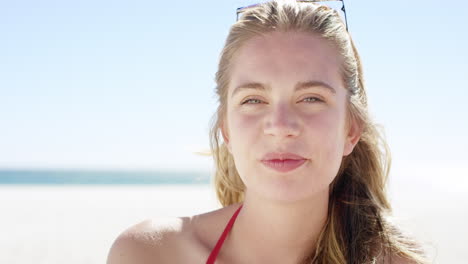 Close-up-portrait-of-beautiful-young-teenage-girl-smiling-on-tropical-beach-slow-motion
