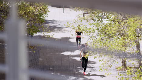 Two-Fitness-athletic-friends-jogging-in-the-urban-city-from-overhead