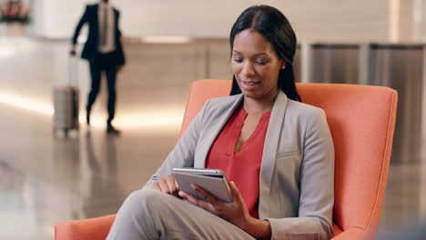 Afroamerikanische-Geschäftsfrau,-Die-In-Der-Hotellobby-An-Einem-Digitalen-Tablet-Arbeitet
