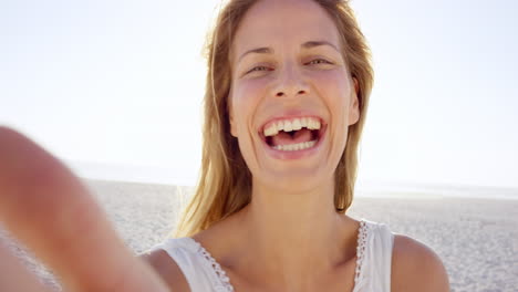 Hermosa-Mujer-Tomando-Selfie-Usando-El-Teléfono-En-La-Playa-Al-Atardecer-Sonriendo-Y-Girando-De-Vacaciones
