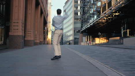 Contemporary-funky-caucasian-businessman-street-dancer-dancing-freestyle-in-the-city