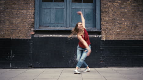 Contemporary-funky-caucasian-woman-street-dancer-dancing-freestyle-in-the-city