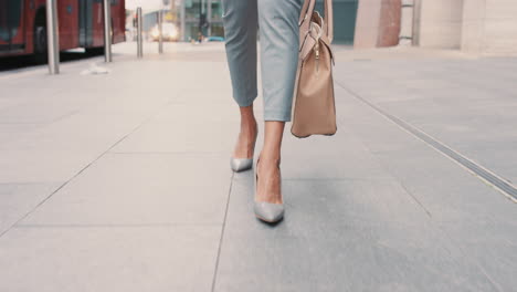 Beautiful-mixed-race-business-woman's-feet-walking-through-city
