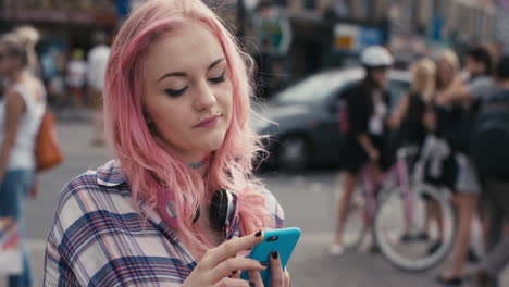 Slow-Motion-Portrait-of-caucasian-girl-with-pink-hair-using-smart-phone