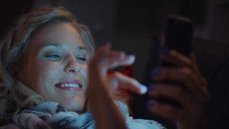 Schöne-Blonde-Frau,-Die-Nachts-Zu-Hause-Smartphone-Technologie-Nutzt