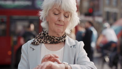 Slow-Motion-Portrait-of-happy-mature-old-woman-using-smart-watch