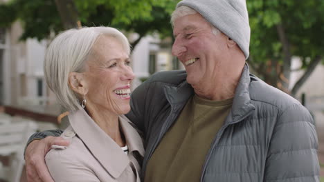 portrait-of-happy-middle-aged-caucasian-couple-smiling-cheerful-embracing-looking-at-camera-old-married-couple-in-city