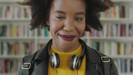 Portrait-African-American-woman-student-smiling-bookshelf-library-university
