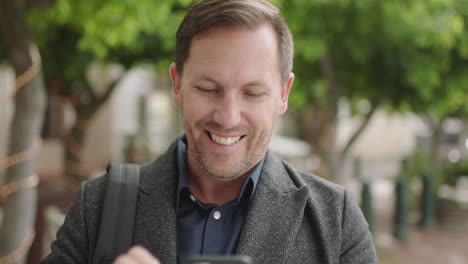 close-up-portrait-of-caucasian-businessman-texting-browsing-using-smartphone-mobile-technology-waiting-in-urban-city-street-enjoying-digital-communication