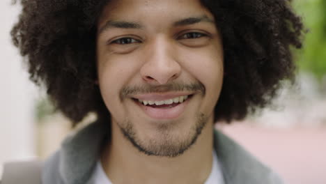close-up-portrait-of-young-mixed-race-student-man-laughing-happy-looking-at-camera-enjoying-independent-lifestyle-in-urban-city-trendy-afro-hairstyle