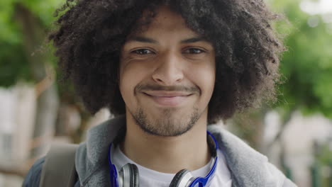 close-up-portrait-of-young-mixed-race-student-man-smiling-confident-looking-at-camera-enjoying-independent-lifestyle-in-urban-city-trendy-afro-hairstyle