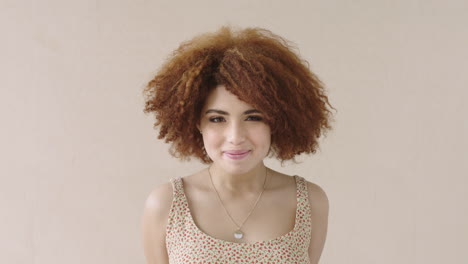 portrait-of-young-shy-mixed-race-woman-with-afro-smiling-bashful-student