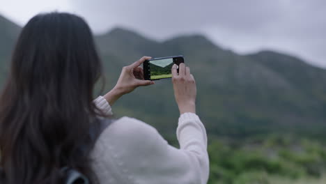 young-indian-woman-hiker-taking-photo-using-smartphone-camera-technology-of-scenic-outdoors-countryside-landscape-enjoying-sharing-travel-adventure-vacation