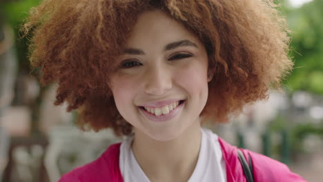 close-up-portrait-of-cute-young-teenage-student-girl-smiling-cheerful-looking-at-camera-lively-woman-trendy-afro-hairstyle