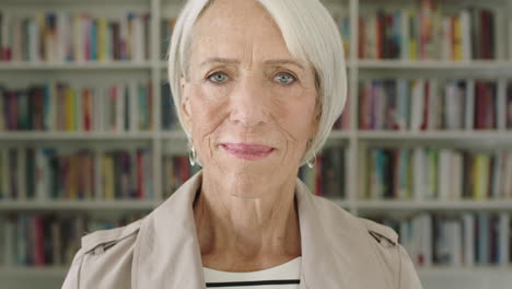 Portrait-elderly-woman-student-smiling-bookshelf-library-university