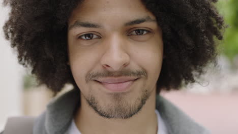 close-up-portrait-of-young-mixed-race-student-man-smiling-confident-looking-at-camera-enjoying-independent-lifestyle-in-urban-city-trendy-afro-hairstyle